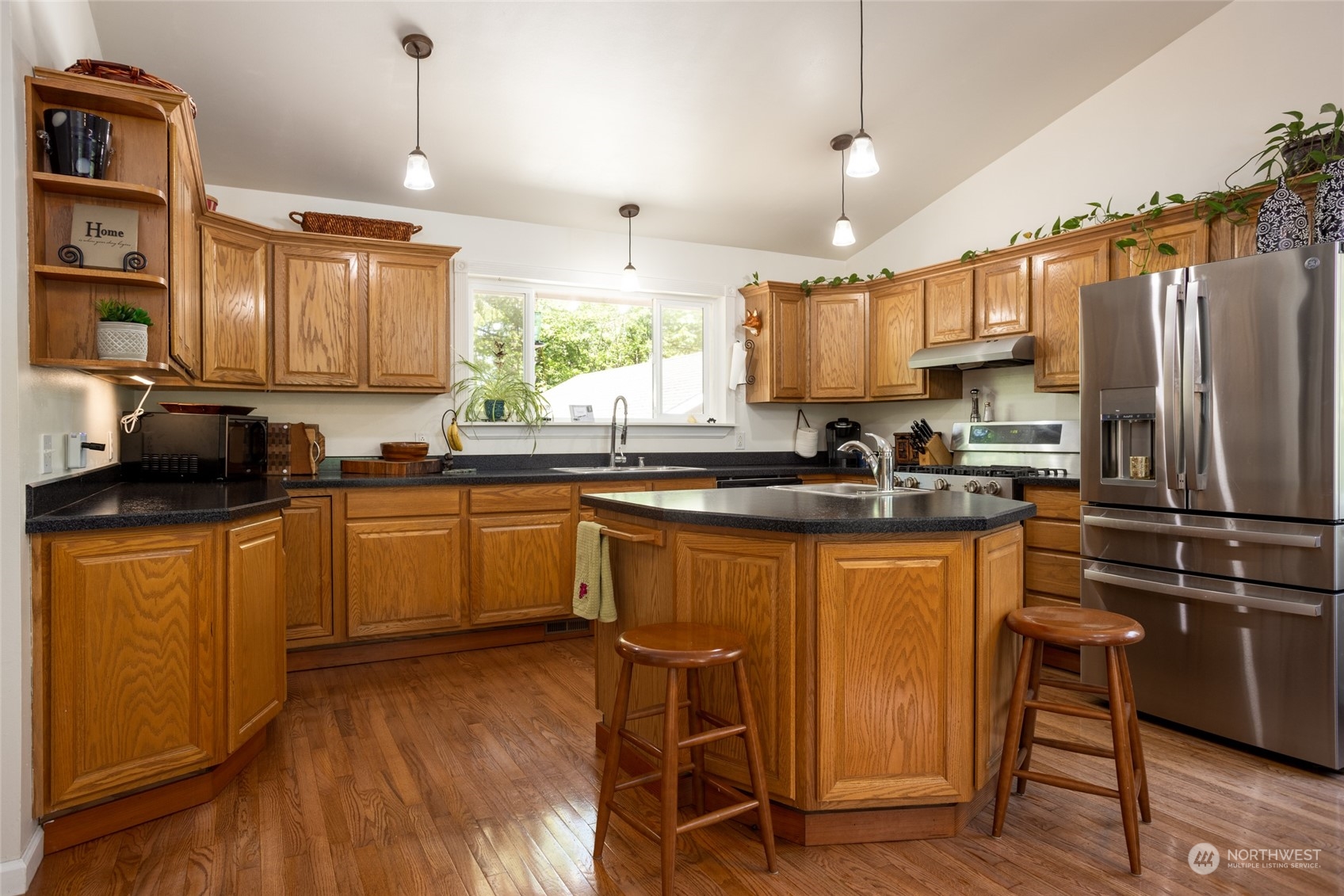 23627 Hoogdal Road Sedro-Woolley, WA 98284 - Photo 7 of 39 a kitchen with stainless steel appliances granite countertop a sink a stove a refrigerator cabinets and a dining table