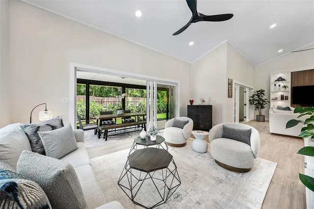 a front view of a house with a garden and tree