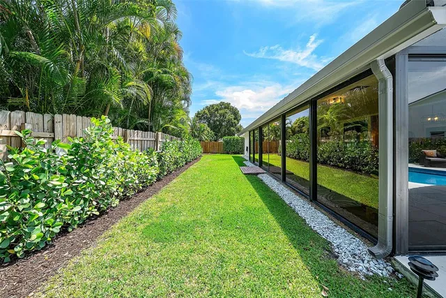 an aerial view of a tennis ground and a yard