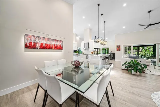 a large kitchen with white cabinets and stainless steel appliances