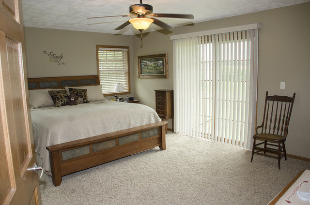 1701 Ridgewood Drive Morrison, IL 61270 - Photo 7 of 19 a bedroom with a bed and a chandelier