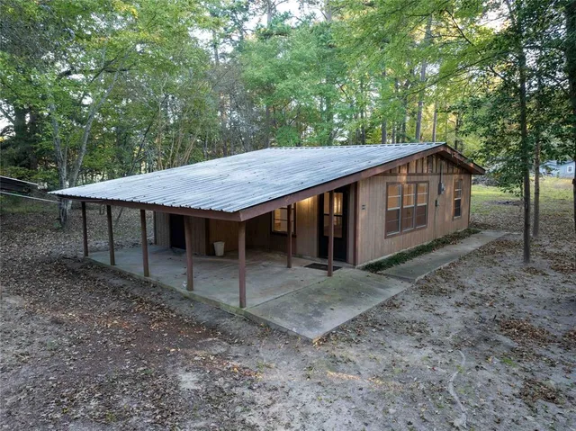 a view of a barn with a table and chairs