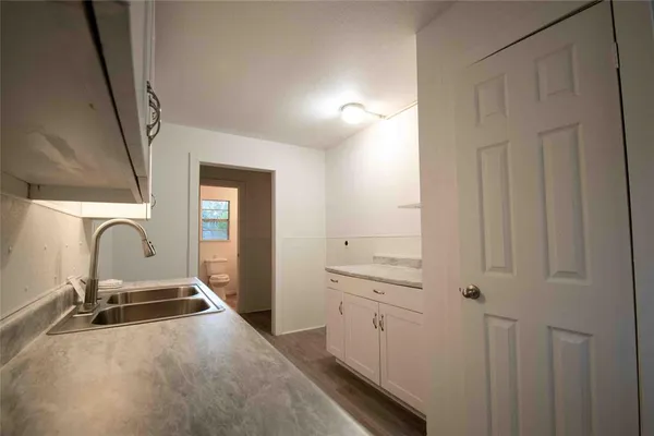 a room with a sink and cabinets