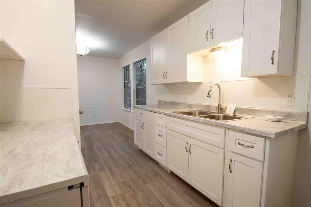 840 Oak Meadow Drive Murchison, TX 75778 - Photo 12 of 27 a kitchen with sink cabinets and stove