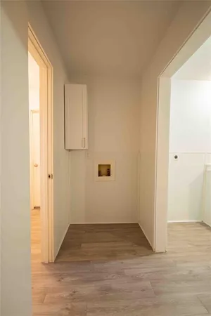 a view of an empty room and wooden floor