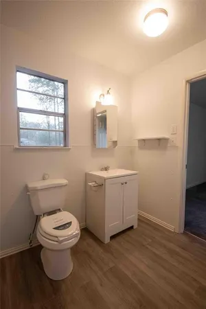 a bathroom with a toilet a sink and a mirror