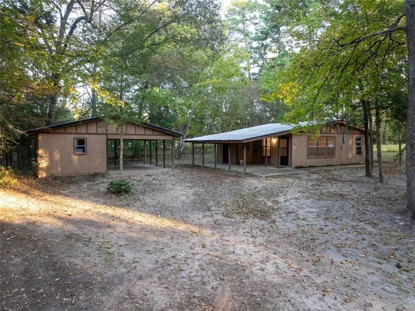 a front view of house with yard and trees