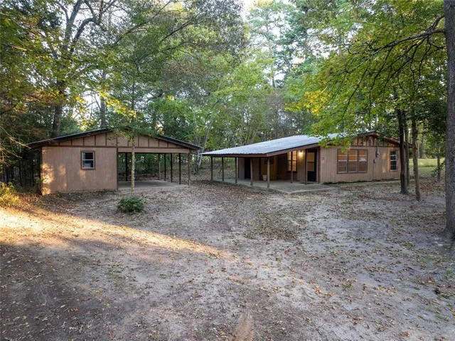 a front view of house with yard and trees