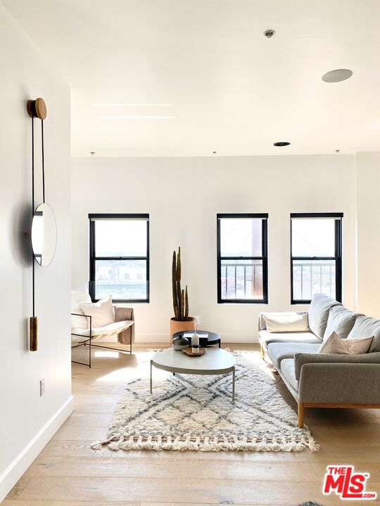 416 South Spring Street, Unit 1210 Los Angeles, CA 90013 - Photo 5 of 15 a living room with furniture and a table