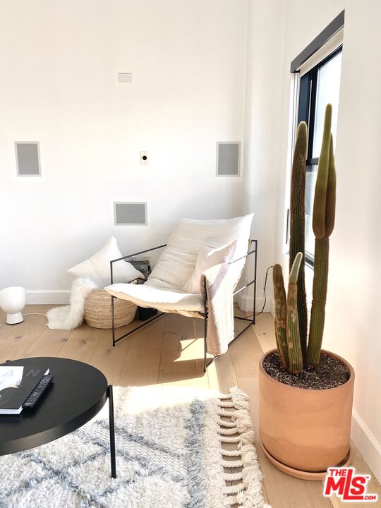 416 South Spring Street, Unit 1210 Los Angeles, CA 90013 - Photo 9 of 15 a living room with furniture a rug and a window