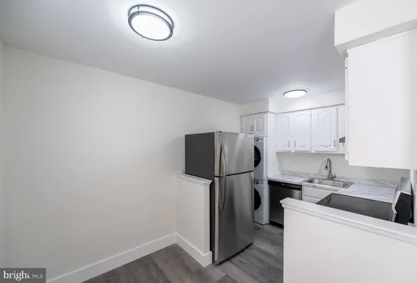 a kitchen with stainless steel appliances a refrigerator sink and cabinets