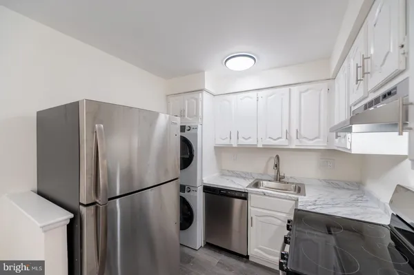 a kitchen with a sink and a stove top oven