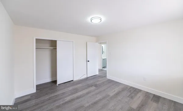 a bedroom with a bed and a walk in closet