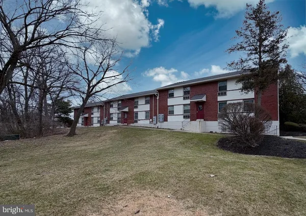 a view of a street with a house in the background