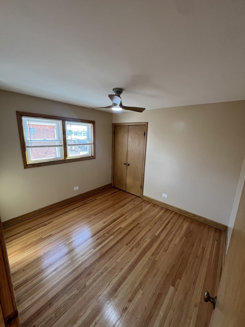 4148 West 87th Street Chicago, IL 60652 - Photo 14 of 16 a view of an empty room with wooden floor and a window