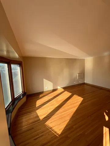 a view of a room with wooden floor and chair