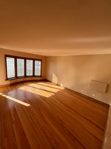 a view of a room with wooden floor and a yard