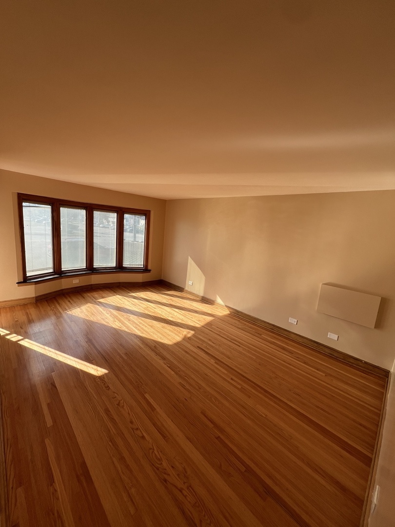 4148 West 87th Street Chicago, IL 60652 - Photo 6 of 16 a view of a room with wooden floor and a yard