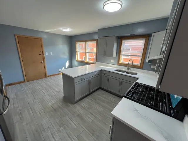 a kitchen with a sink stove and cabinets