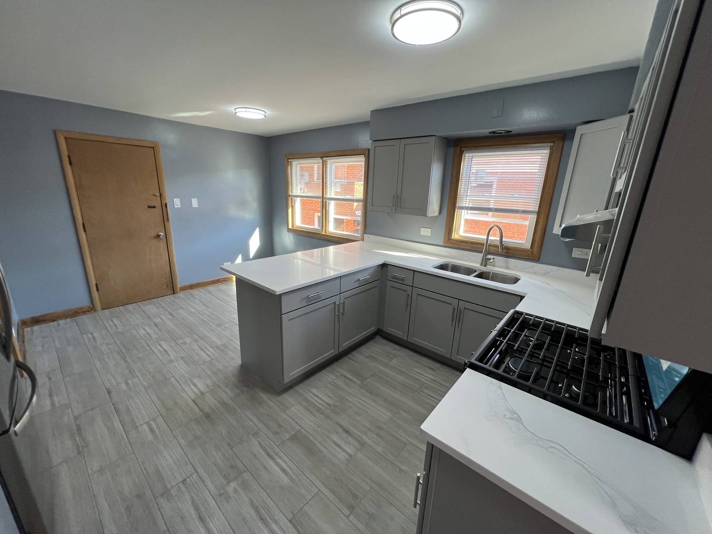 4148 West 87th Street Chicago, IL 60652 - Photo 7 of 16 a kitchen with a sink stove and cabinets