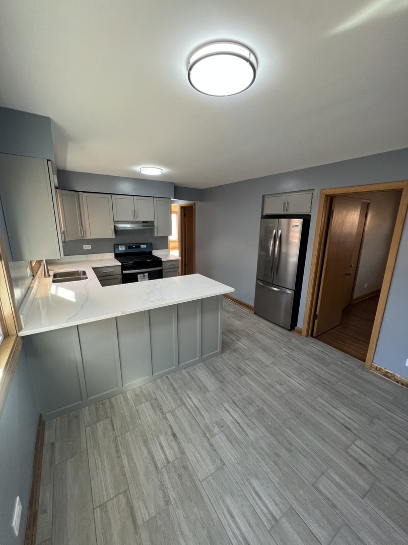 4148 West 87th Street Chicago, IL 60652 - Photo 9 of 16 a room with a bed and a mirror