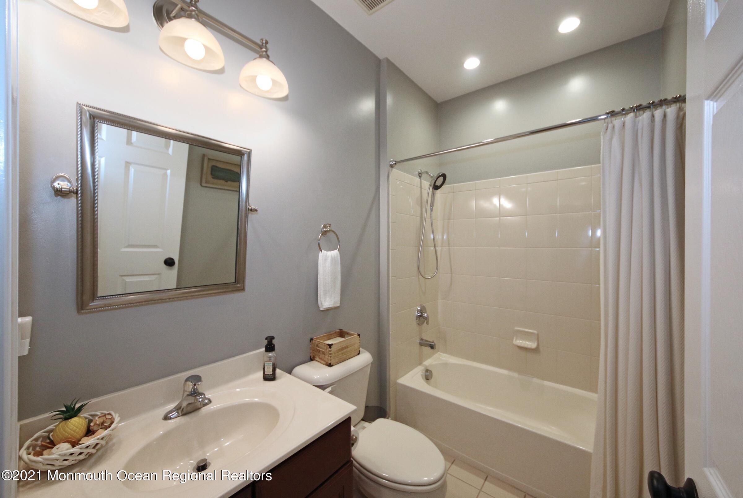 502 Abby Road Middletown, NJ 07748 - Photo 13 of 24 a bathroom with a granite countertop sink toilet and shower
