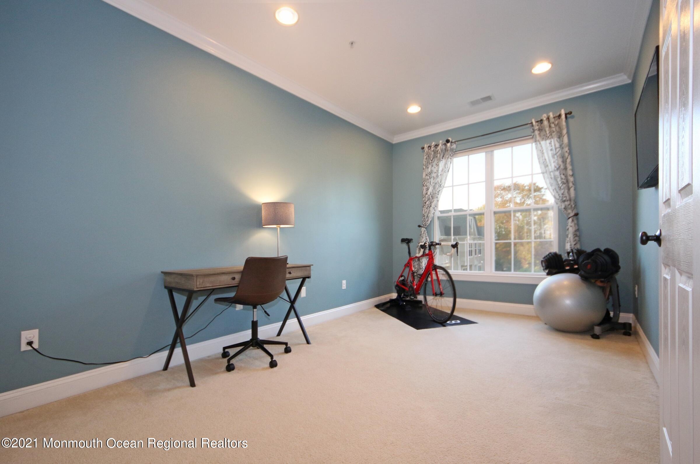 502 Abby Road Middletown, NJ 07748 - Photo 14 of 24 a view of a room with gym equipment and windows