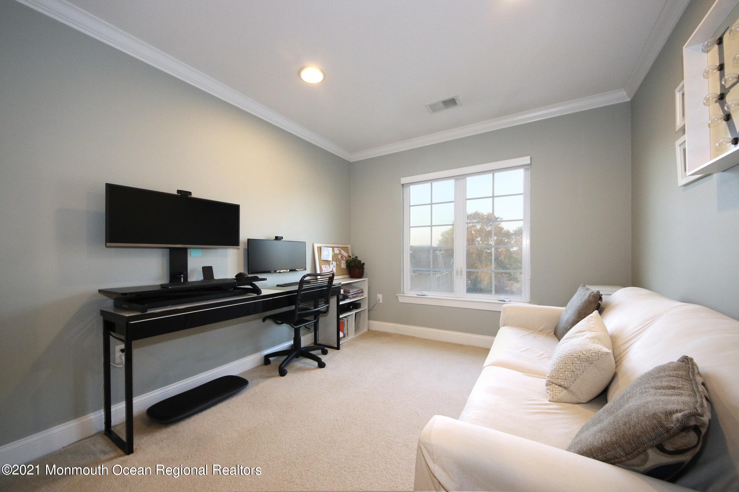 502 Abby Road Middletown, NJ 07748 - Photo 19 of 24 a living room with furniture and a flat screen tv