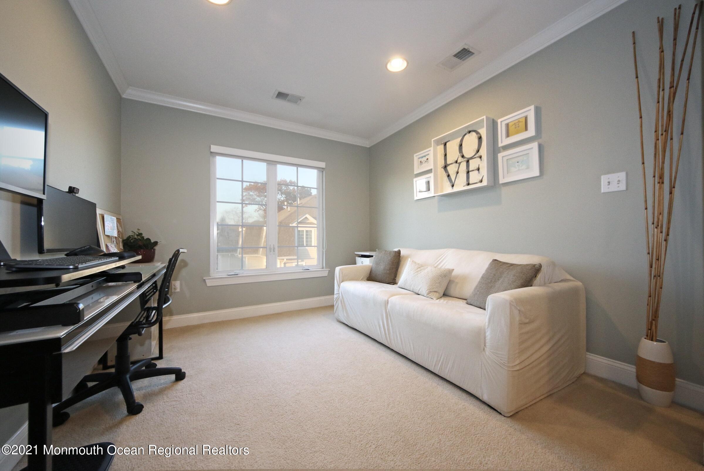 502 Abby Road Middletown, NJ 07748 - Photo 20 of 24 a living room with furniture and a flat screen tv