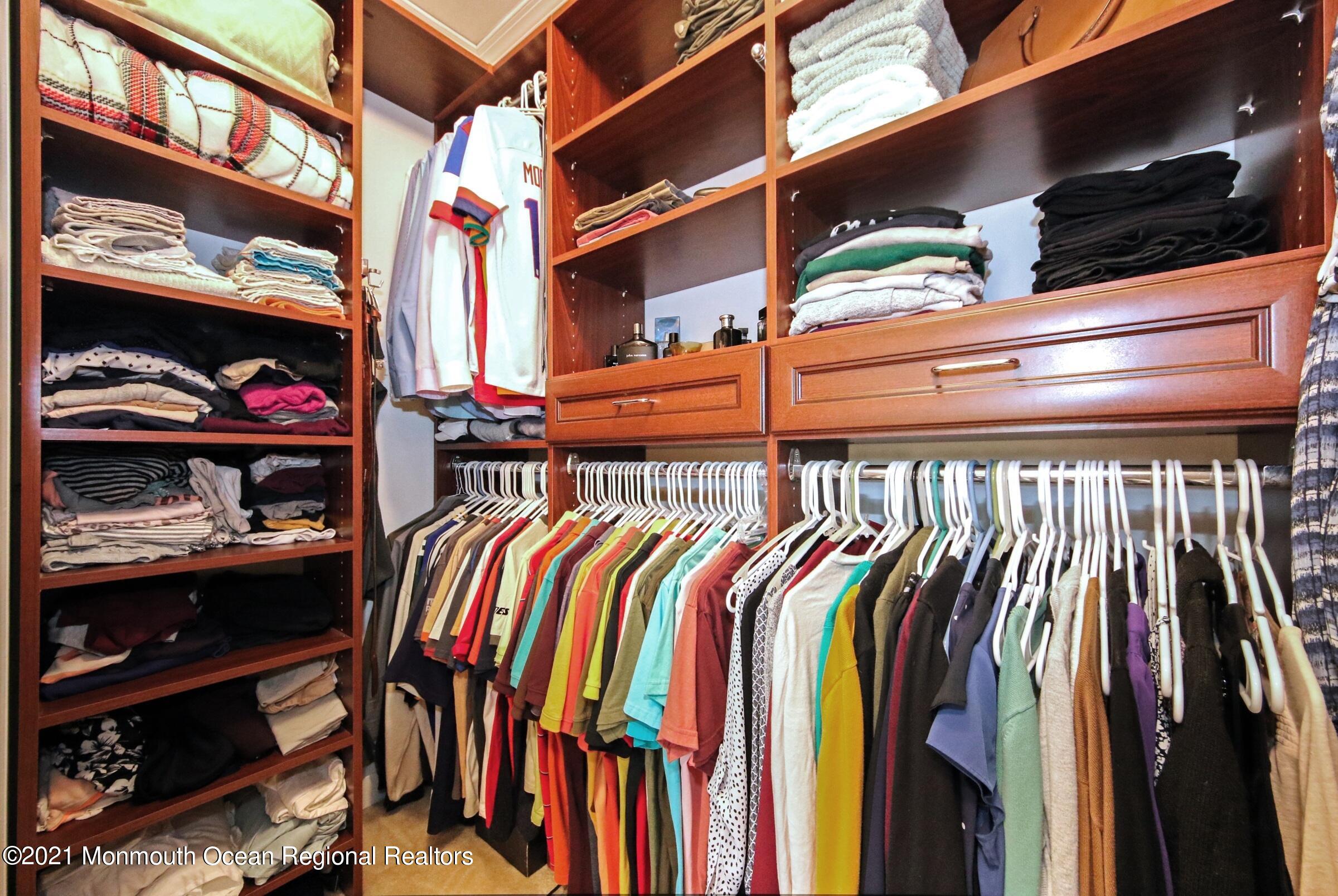 502 Abby Road Middletown, NJ 07748 - Photo 23 of 24 a view of walk in closet with clothes and shoes