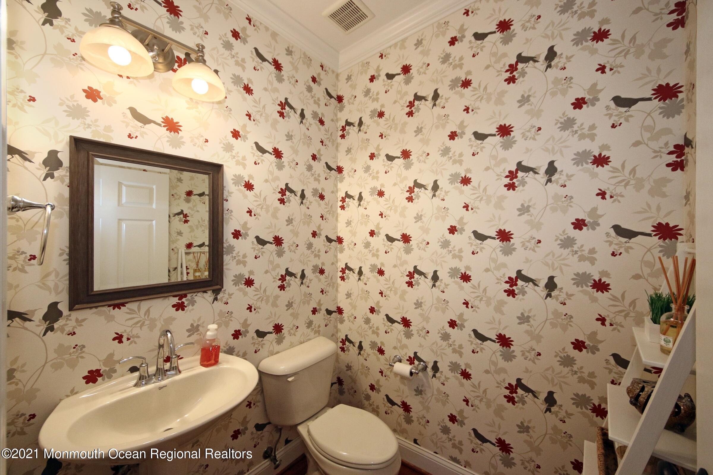 502 Abby Road Middletown, NJ 07748 - Photo 7 of 24 a bathroom with a sink toilet and mirror