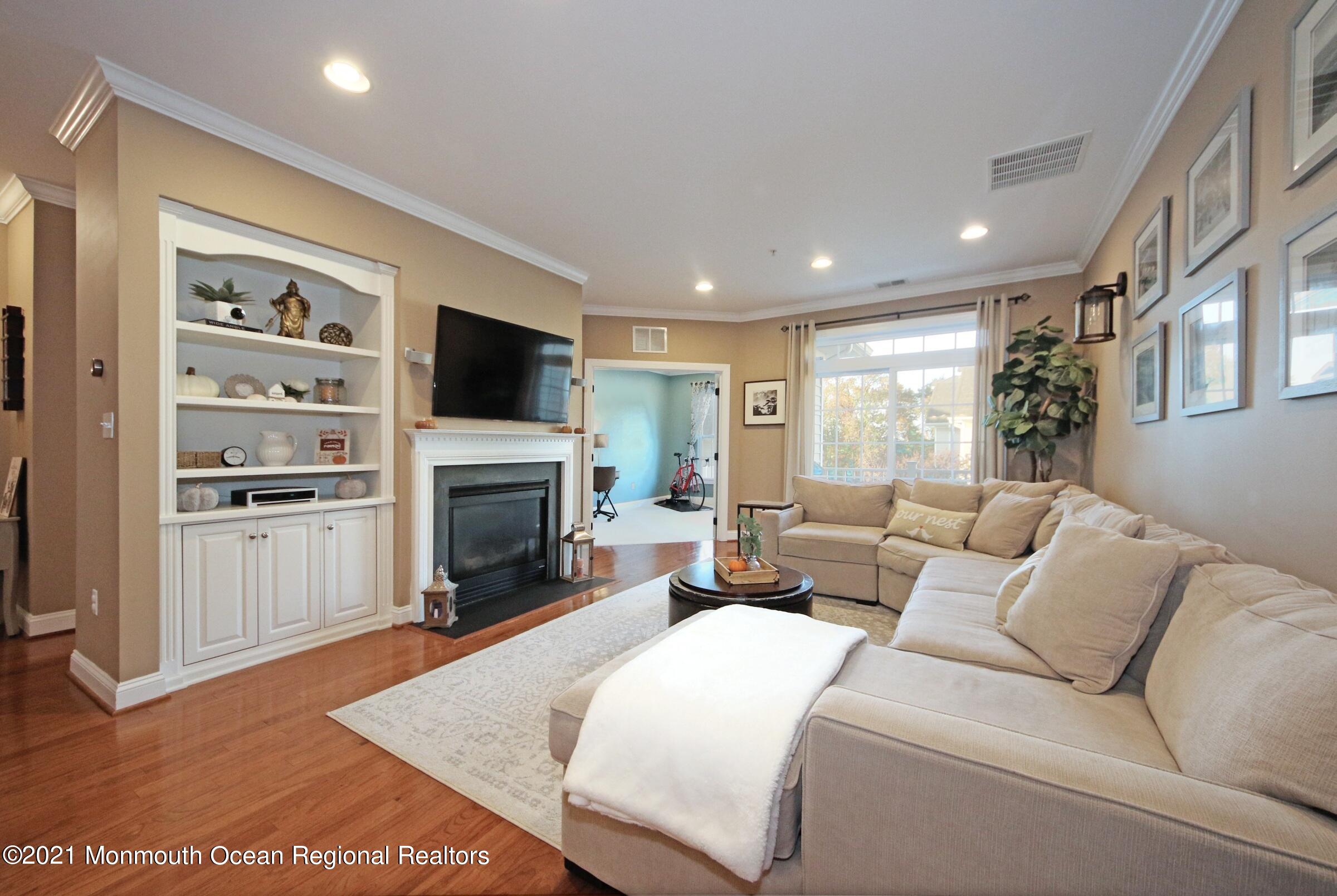 502 Abby Road Middletown, NJ 07748 - Photo 10 of 24 a living room with furniture a fireplace and a flat screen tv