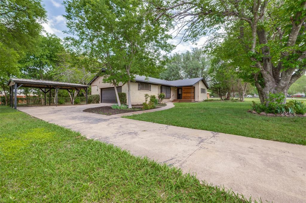 1533 East Springcrest Circle Lancaster, TX 75134 - Photo 1 of 25 Single-story home featuring a stucco exterior and wood-paneled accents