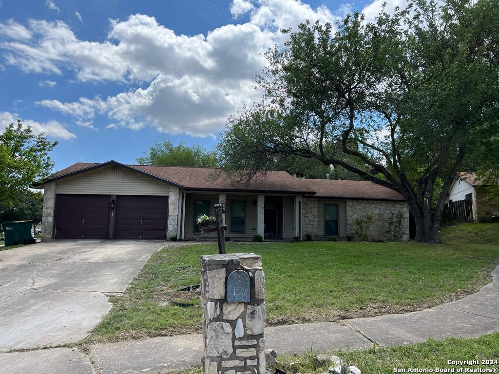 a front view of a house with yard and green space