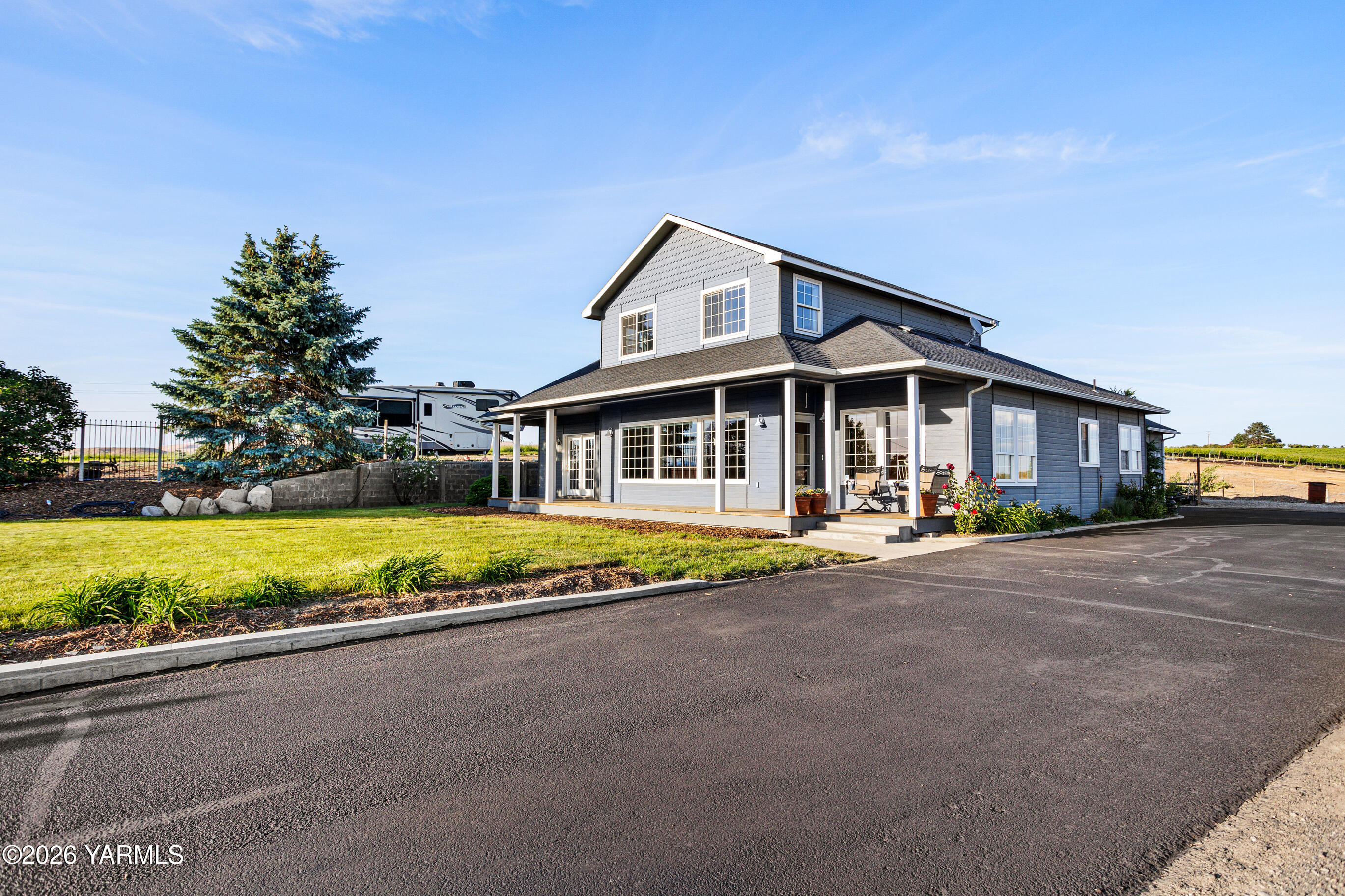 5060 Lombard Loop Road Zillah, WA 98953 - Photo 1 of 65 a view of swimming pool with outdoor seating and house in the background