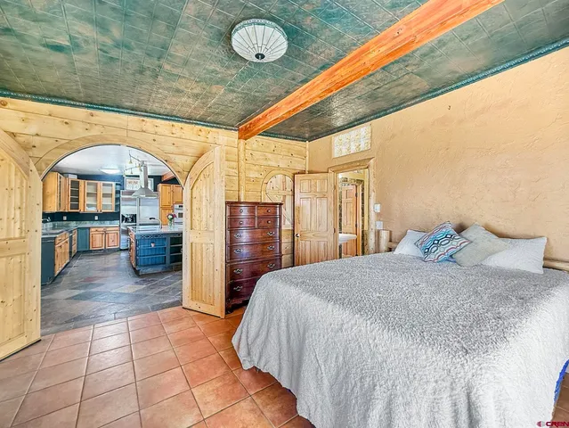 a large room with a bed and a large window