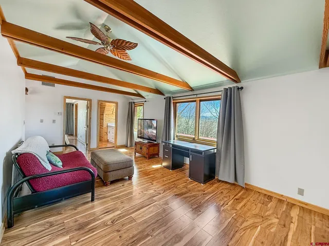 a bedroom with furniture and a large window