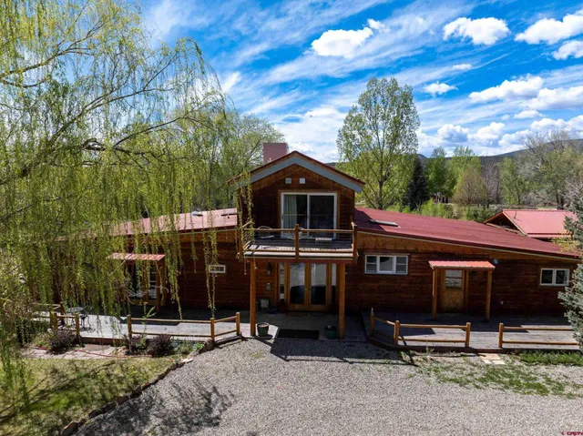 a front view of house with yard and parking space