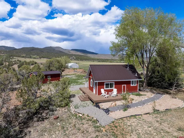 front view of a house with a yard and mountain view