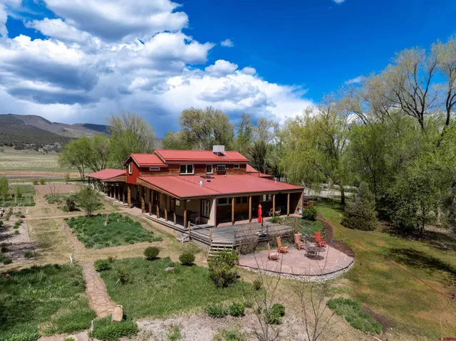 a view of a house with swimming pool and sitting area