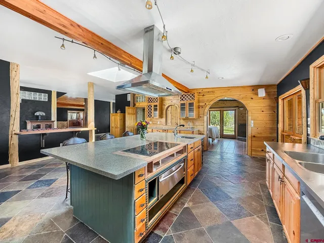 a large kitchen with stainless steel appliances granite countertop a large center island and a sink