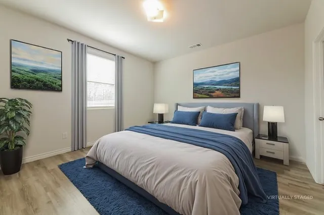 a bedroom with bed and window