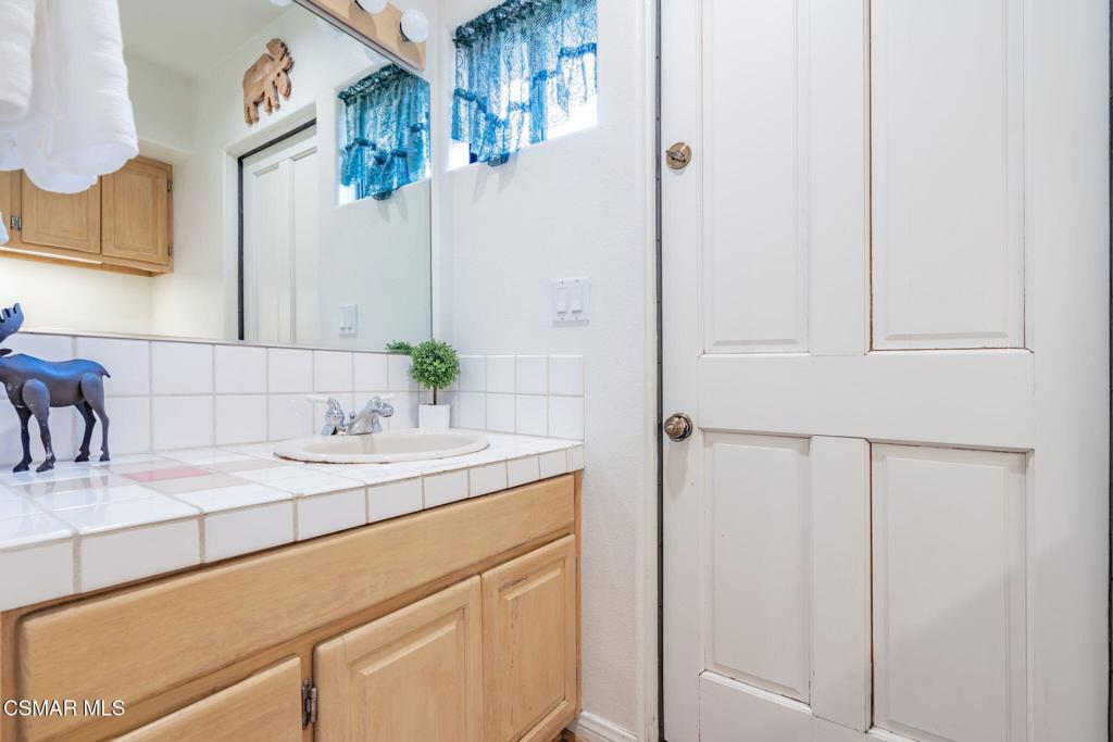 6078 Peppertree Lane Simi Valley, CA 93063 - Photo 29 of 59 a bathroom with a sink and a mirror