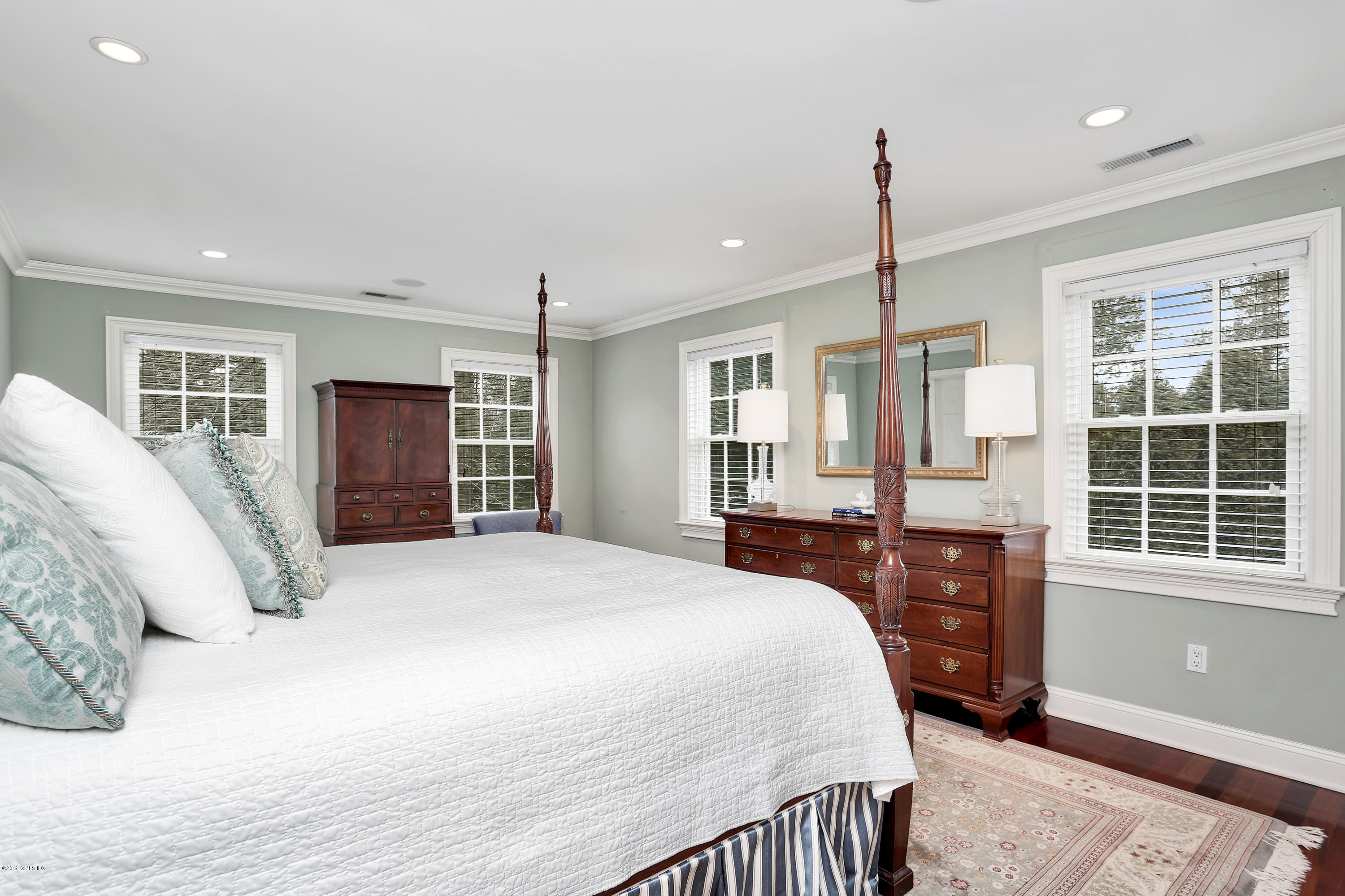99 Lockwood Road Riverside, CT 06878 - Photo 15 of 21 a spacious bedroom with a large bed and a dresser