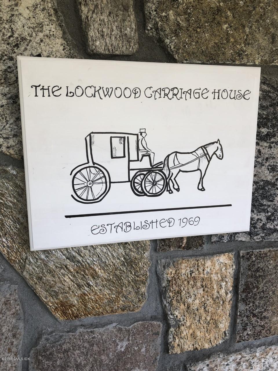99 Lockwood Road Riverside, CT 06878 - Photo 2 of 21 a sign that is on a wooden wall