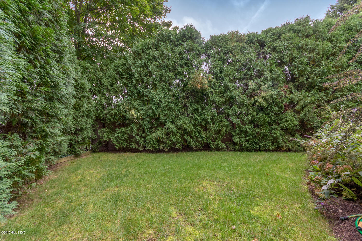 99 Lockwood Road Riverside, CT 06878 - Photo 21 of 21 a view of a green field with plants in front of it