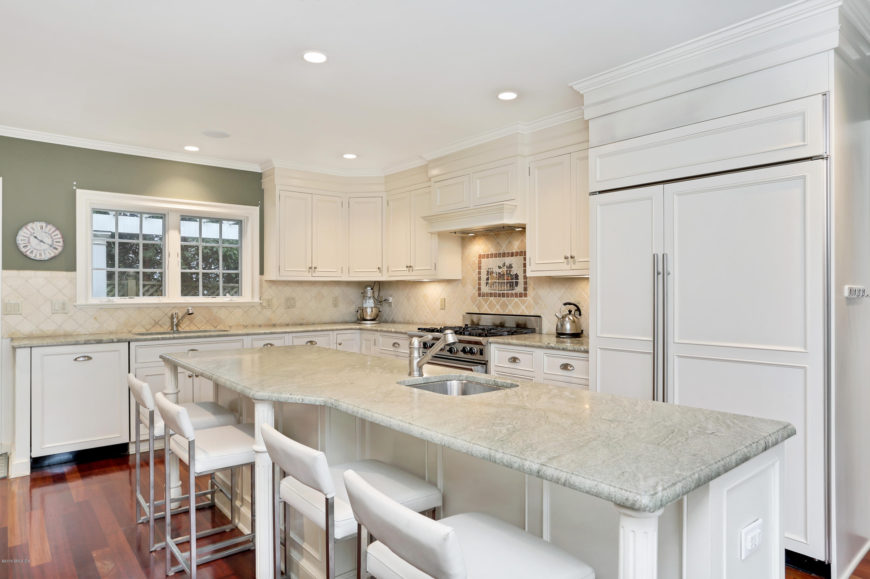 99 Lockwood Road Riverside, CT 06878 - Photo 10 of 21 a kitchen with a table chairs refrigerator and cabinets
