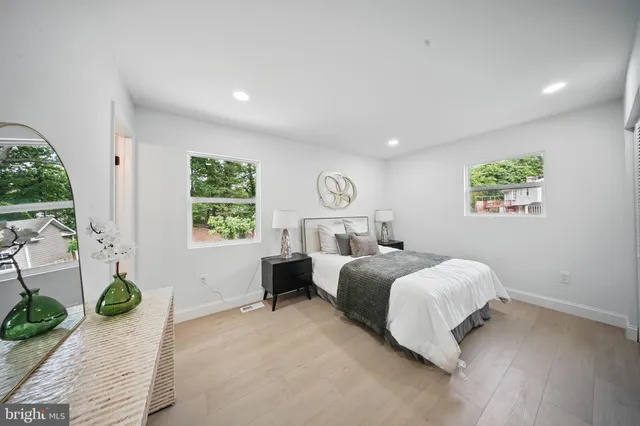 a spacious bedroom with a bed and a large window