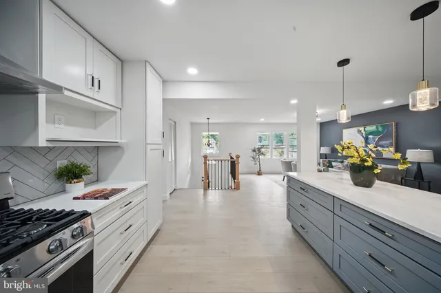 a kitchen with stainless steel appliances a sink a stove top oven a counter space and cabinets