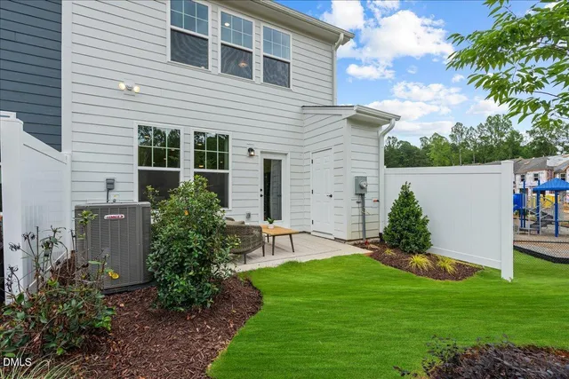 a view of a house with a yard and plants
